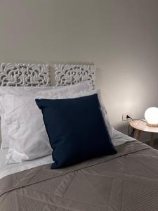 a blue pillow sitting on top of a bed at Demetra Bed in Lizzanello