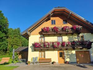 a building with flower boxes on the side of it at Ferienhaus Laimerbauer in Faistenau
