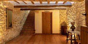 a hallway with stairs and a door in a building at Fonda Angeleta in Valderrobres +1 photo