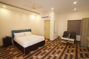 a bedroom with a bed and a table and chairs at Simbaa Resorts and Conventions 