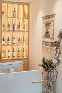 a room with a shelf of wine bottles at TOTOLO Winery Vacation Homestay in Yinchuan