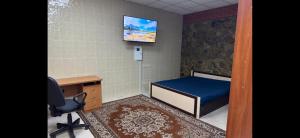 a room with a bed and a desk and a chair at Днестровский in Kharkiv