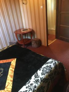 a bedroom with a bed and a table and a chair at Willa Sara in Okuninka