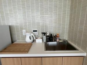 a kitchen counter with a sink and a mixer at Thousand Garden Tarumizu in Tarumizu