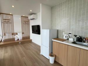 a kitchen with a refrigerator and a sink at Thousand Garden Tarumizu in Tarumizu
