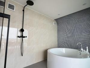a bathroom with a bath tub and a shower at Thousand Garden Tarumizu in Tarumizu +157 photos