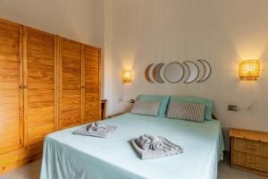 a bedroom with a bed with towels on it at Terrazza porto San Paolo in Porto San Paolo +26 photos