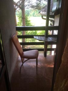a chair sitting in front of a window at Willa Sara in Okuninka +85 photos
