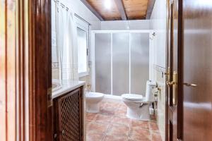a bathroom with a toilet and a sink at Los Rosales in Burunchel +22 photos