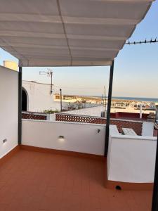 a balcony with a view of the ocean at Casa Conil Cruz in Conil de la Frontera