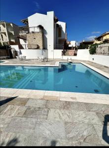 a large swimming pool in front of a house at Terrazza porto San Paolo in Porto San Paolo