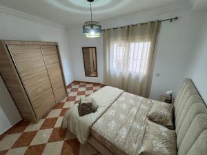 a bedroom with a bed and a checkered floor at Casa nueva in Oulad Akkou