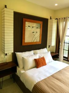 a bedroom with a large bed with white pillows at Một Nhà Thơ Homestay in Hương Trà