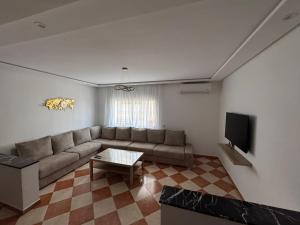 a living room with a couch and a tv at Casa nueva in Oulad Akkou