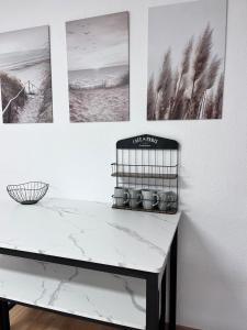a white counter with four pictures on the wall at Fe-Wo im Herzen von Weingarten in Niederdorla