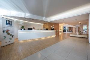 a lobby of a hotel with a reception desk at iH Hotels Milano Watt 13 in Milan