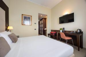 a hotel room with a bed and a desk at iH Hotels Milano Watt 13 in Milan