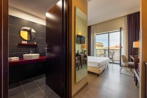 a hotel room with a bathroom with a view at iH Hotels Milano Watt 13 in Milan