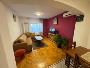 a living room with a couch and a table at Apartments Aurora in Bar