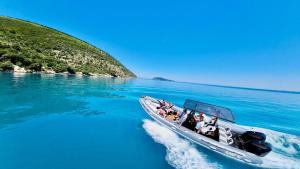 a group of people on a boat in the water at New Donantelo Hotel in Vlorë