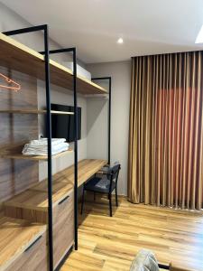 a room with a bed and a desk at New Donantelo Hotel in Vlorë +100 photos