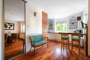 a kitchen and dining room with a table and chairs at Urban Spa House Jacuzzi, Sauna, Taras & Grill ! No Parties in Warsaw