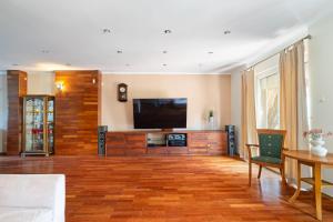 a large living room with a flat screen tv at Jacuzzi & BBQ Family Villa - No Parties Allowed in Warsaw