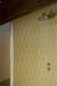 a bathroom with a shower with yellow tile at Scavolo Borgo in SantʼAgata Feltria +20 photos
