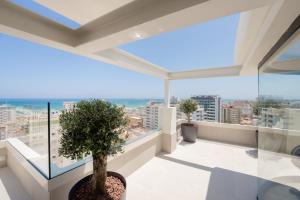 a view from the balcony of a building with a tree at Hotel RH Arena - Todo Incluido in Gandía