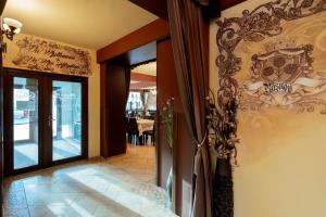 a entrance to a restaurant with a glass door at MAX International Hotel in Râşnov +190 photos