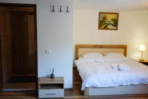 Postel nebo postele na pokoji v ubytování Pensiunea Laura