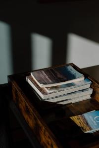 a pile of books sitting on top of a table at Private guest suite in Central Wanaka in Wanaka
