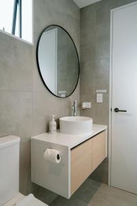 a bathroom with a sink and a mirror at Private guest suite in Central Wanaka in Wanaka