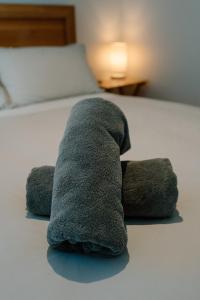 a stuffed animal is laying on a bed at Private guest suite in Central Wanaka in Wanaka