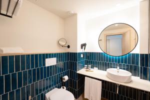 a bathroom with a sink and a mirror at Hotel RH Arena - Todo Incluido in Gandía