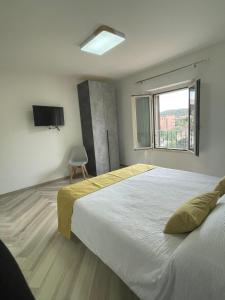 a bedroom with a large bed and a window at B&B Dimora Mediterranea - La Maddalena in La Maddalena