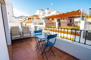 a patio with a table and chairs on a balcony at Marbella Village in Marbella