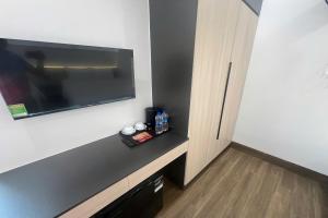 a room with a flat screen tv on a wall at Thao Trang Luxury Hotel Quang Binh in Dong Hoi