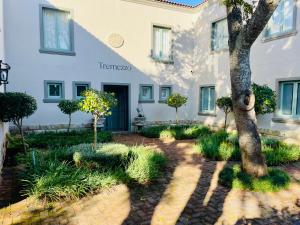 a building with a tree in front of it at Tremezzo Villa in Plettenberg Bay