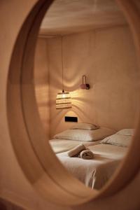 a bedroom with two beds and a round mirror at Casa Albaredo, Aldea Rural, Boutique Hotel, Retreat, in O Cebrero +91 photos