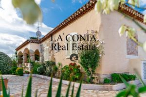 a building with a sign that reads la corona real estate at blue sea villa in Cannigione +8 photos