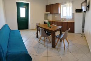 a kitchen and dining room with a table and chairs at Skoulianika House in Kythira