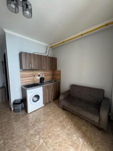 a living room with a washing machine and a couch at Tiko's Apartments in Gonio in Gonio +11 photos