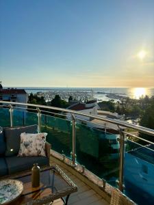 a balcony with a couch and a table on a roof at Mia Bella in Bar +34 photos