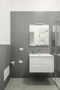 a white bathroom with a sink and a mirror at Buongiorno Vicenza! in Vicenza