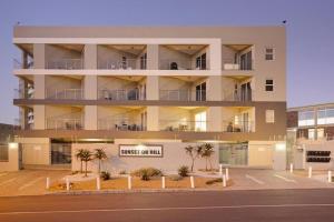 an apartment building with a sign that reads sunset my mind at Sunset On Hill 3 in Bloubergstrand