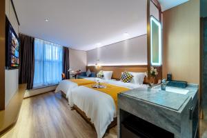 Postel nebo postele na pokoji v ubytování Huandong Manyi Hotel