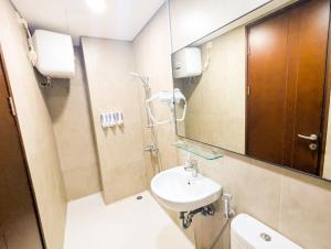 a bathroom with a sink and a mirror at Lovina 12-19 Pollux Meisterstadt in Batam Center +3 photos