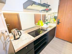 a kitchen with a sink and a kettle on a counter at Lovina 12-19 Pollux Meisterstadt in Batam Center