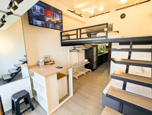 a loft apartment with a desk and bunk beds at Lovina 12-19 Pollux Meisterstadt in Batam Center